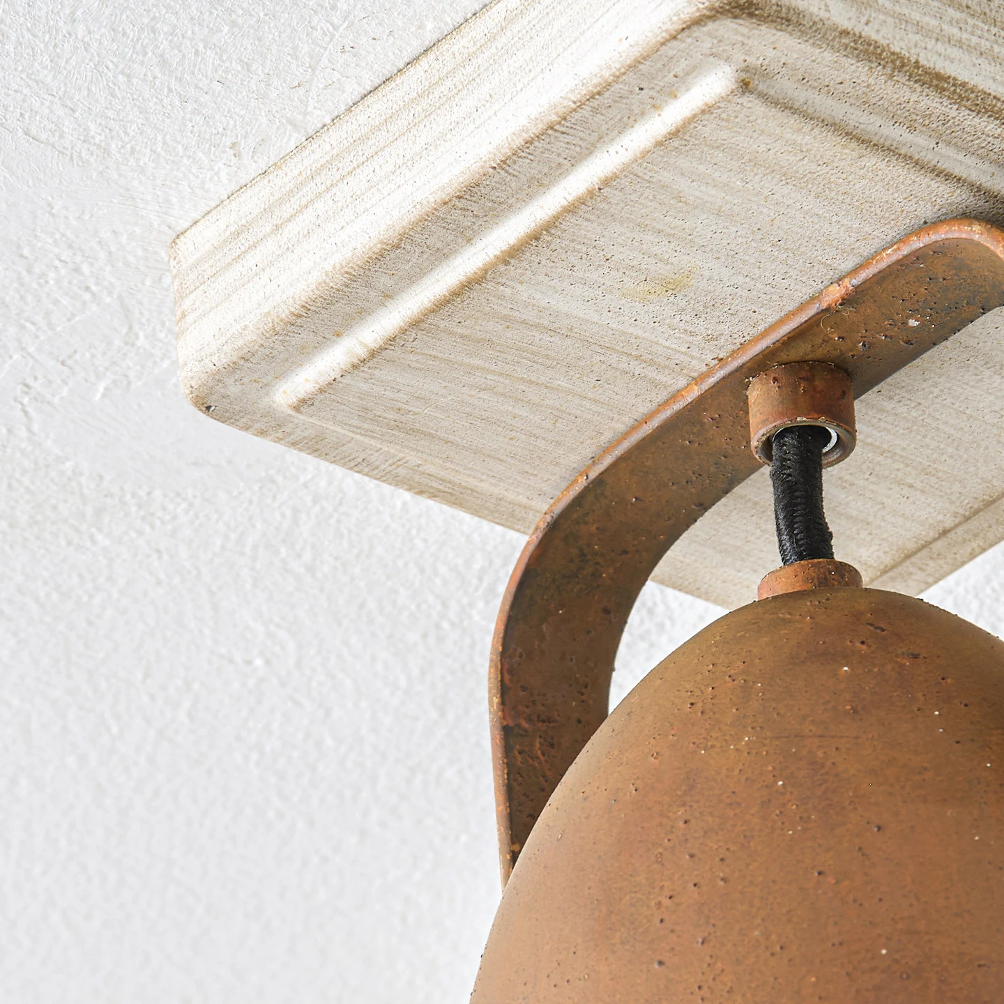 White ceiling mount and adjustable rust bracket detail