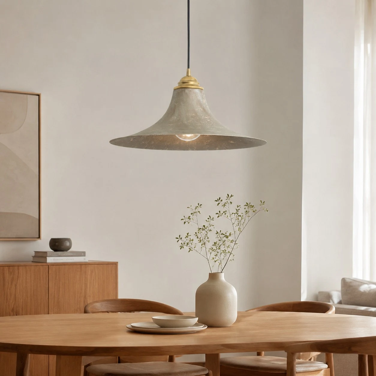 Aged brass pendant lamp over a warm dining table