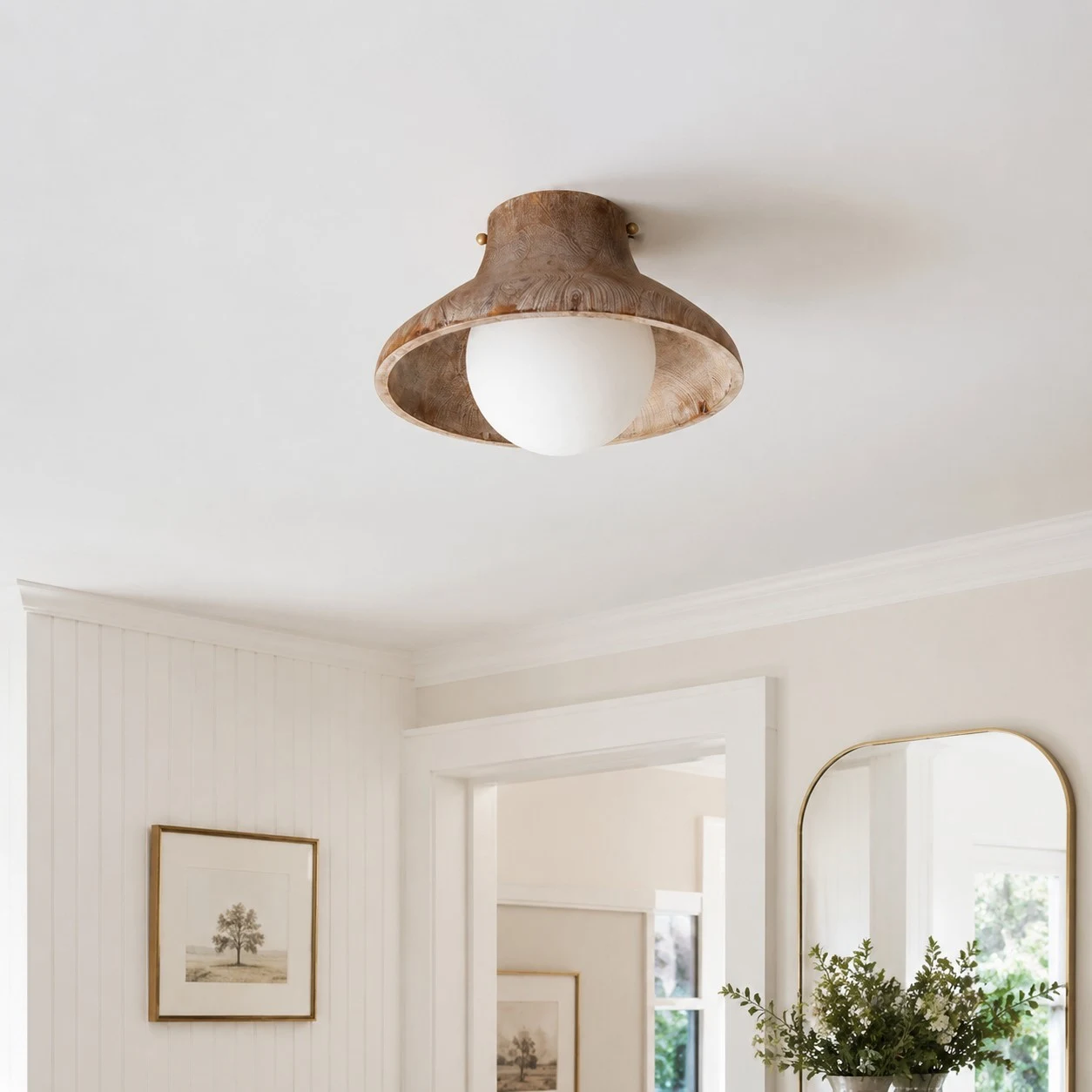 Natural wood ceiling light installed near an entryway mirror