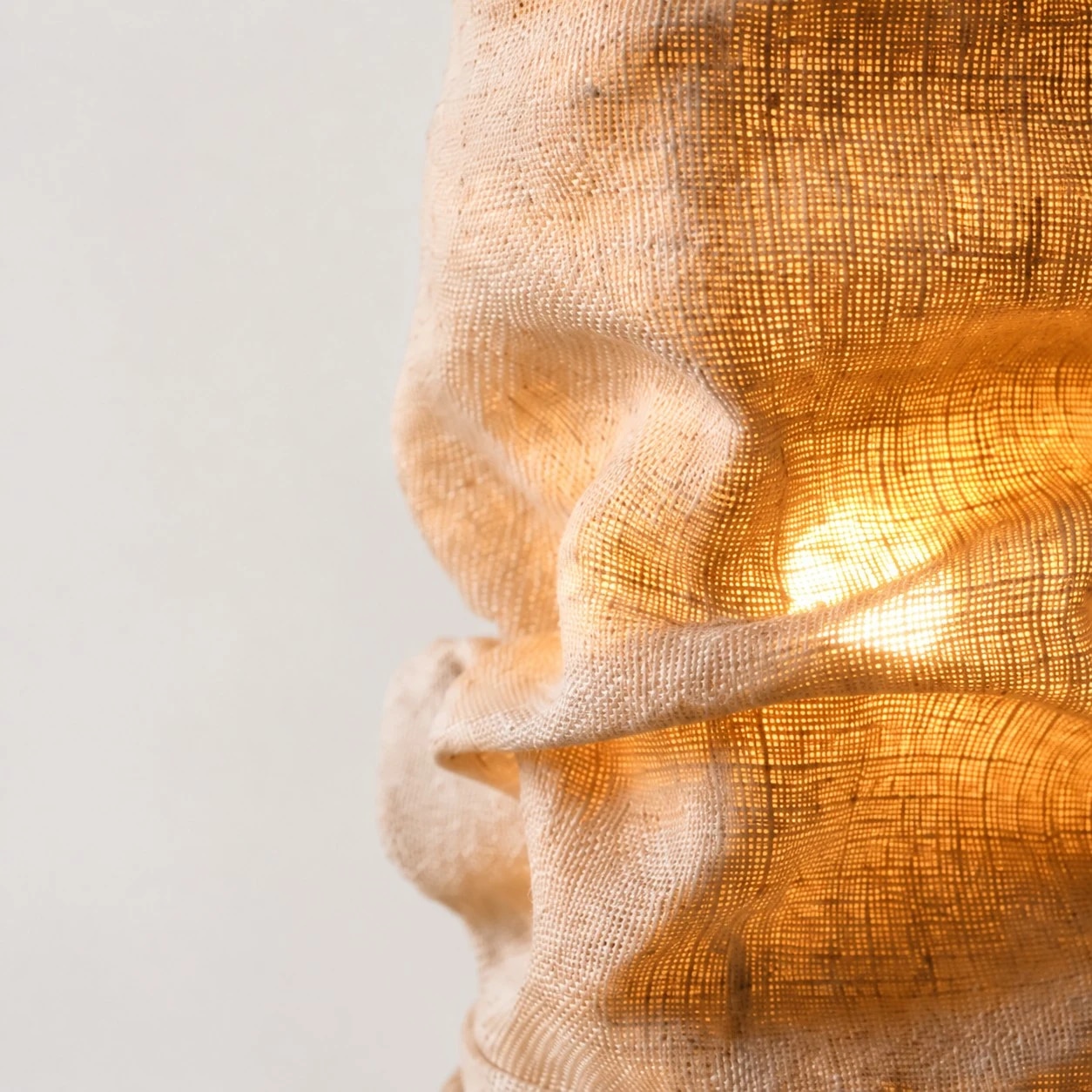 Close-up of gathered burlap texture and warm glow