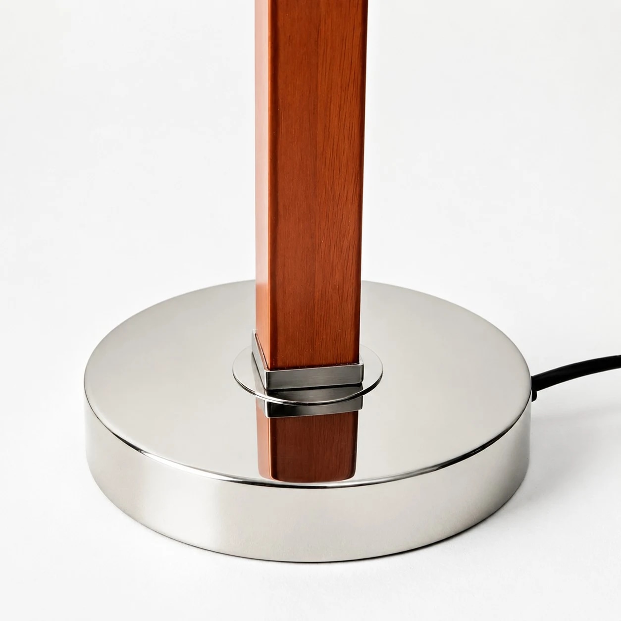 Round polished metal base and wood stem detail