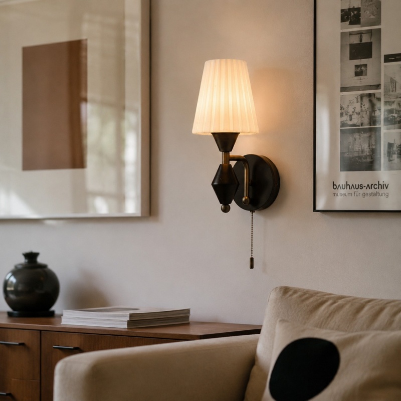 Wall sconce installed beside framed artwork