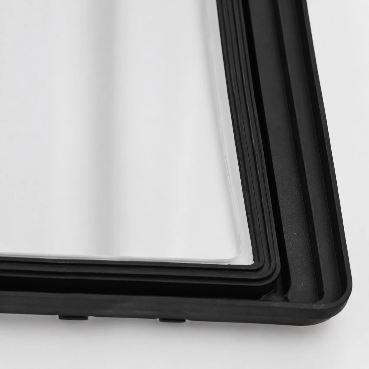 Close-up of black frame and white glass shade