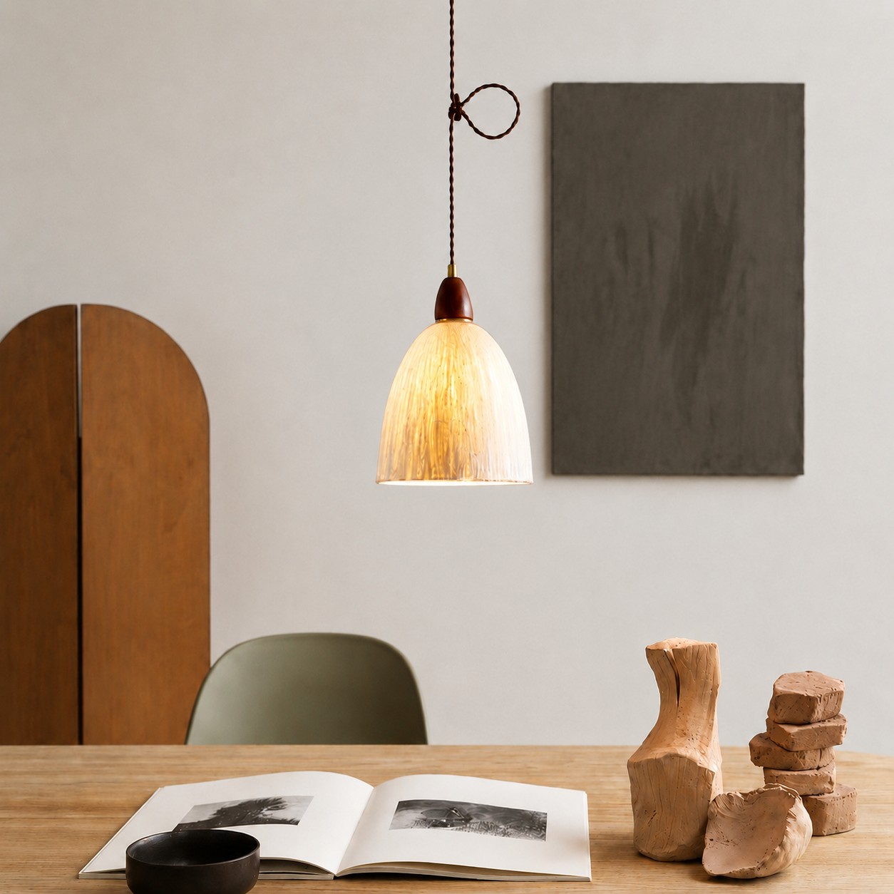 Tall rice paper pendant light over a table