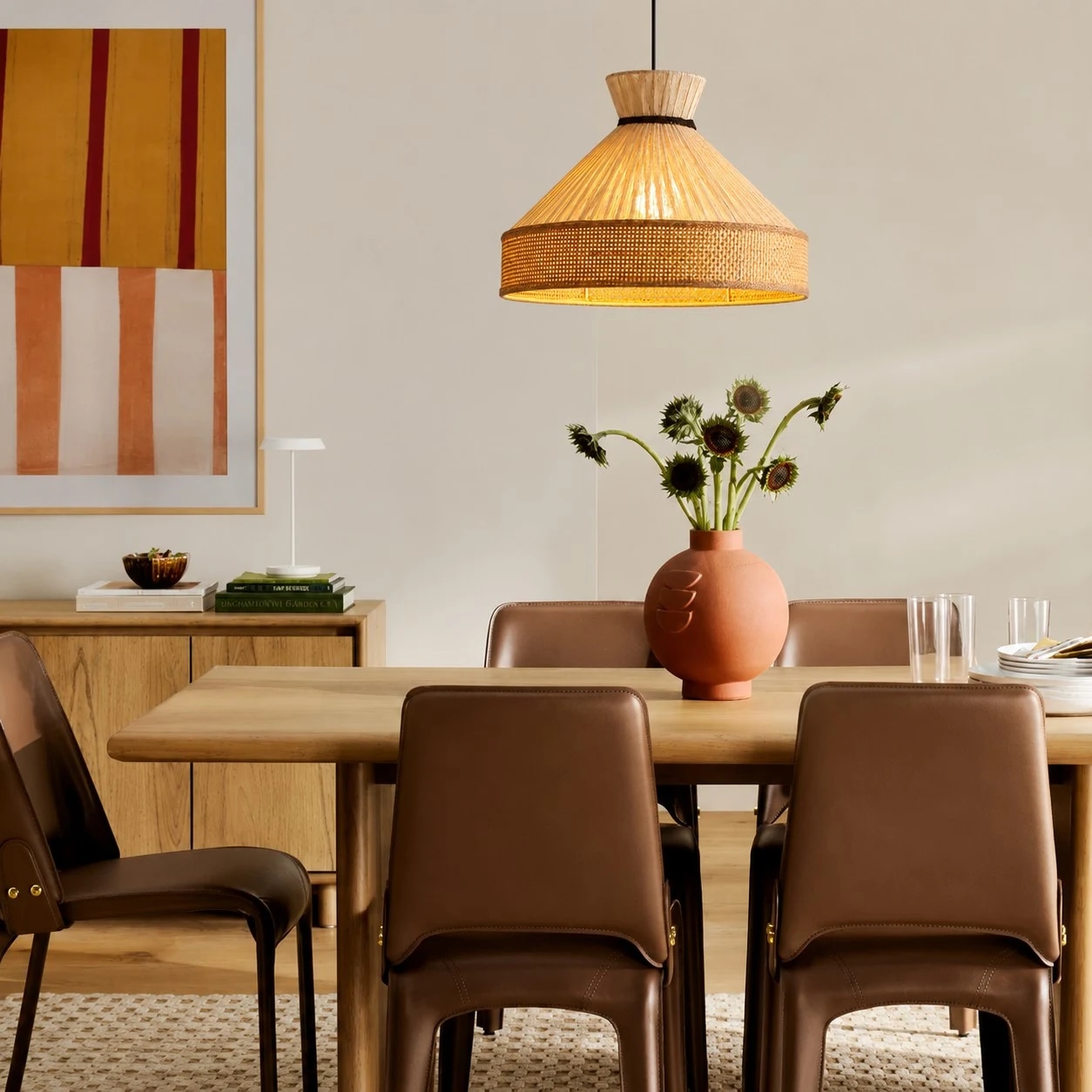 Warm fabric cone pendant light in a dining room with wall art