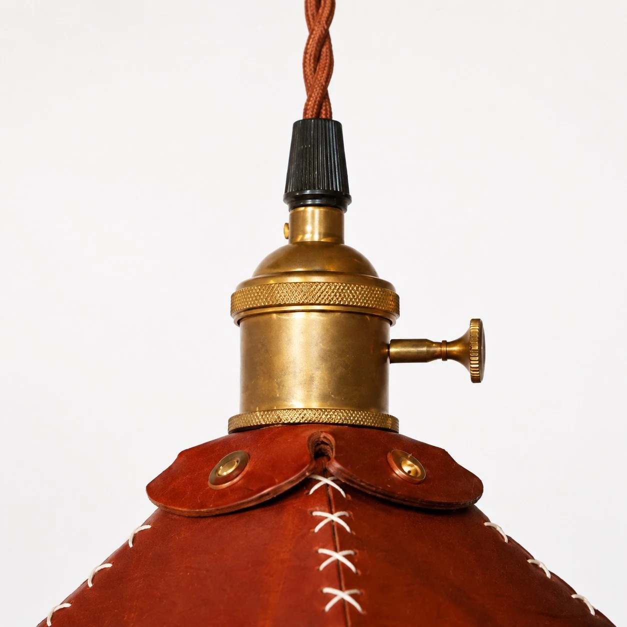 Antique brass-tone metal cap and twisted cord detail
