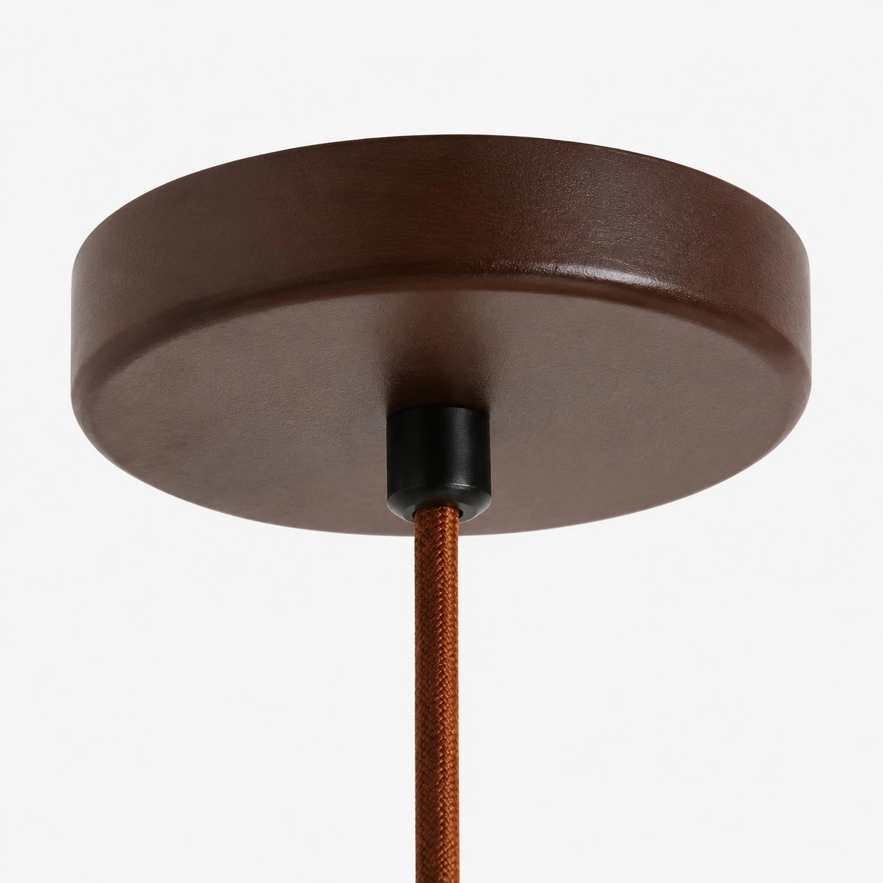 Round wood canopy and woven cord detail of the pendant light