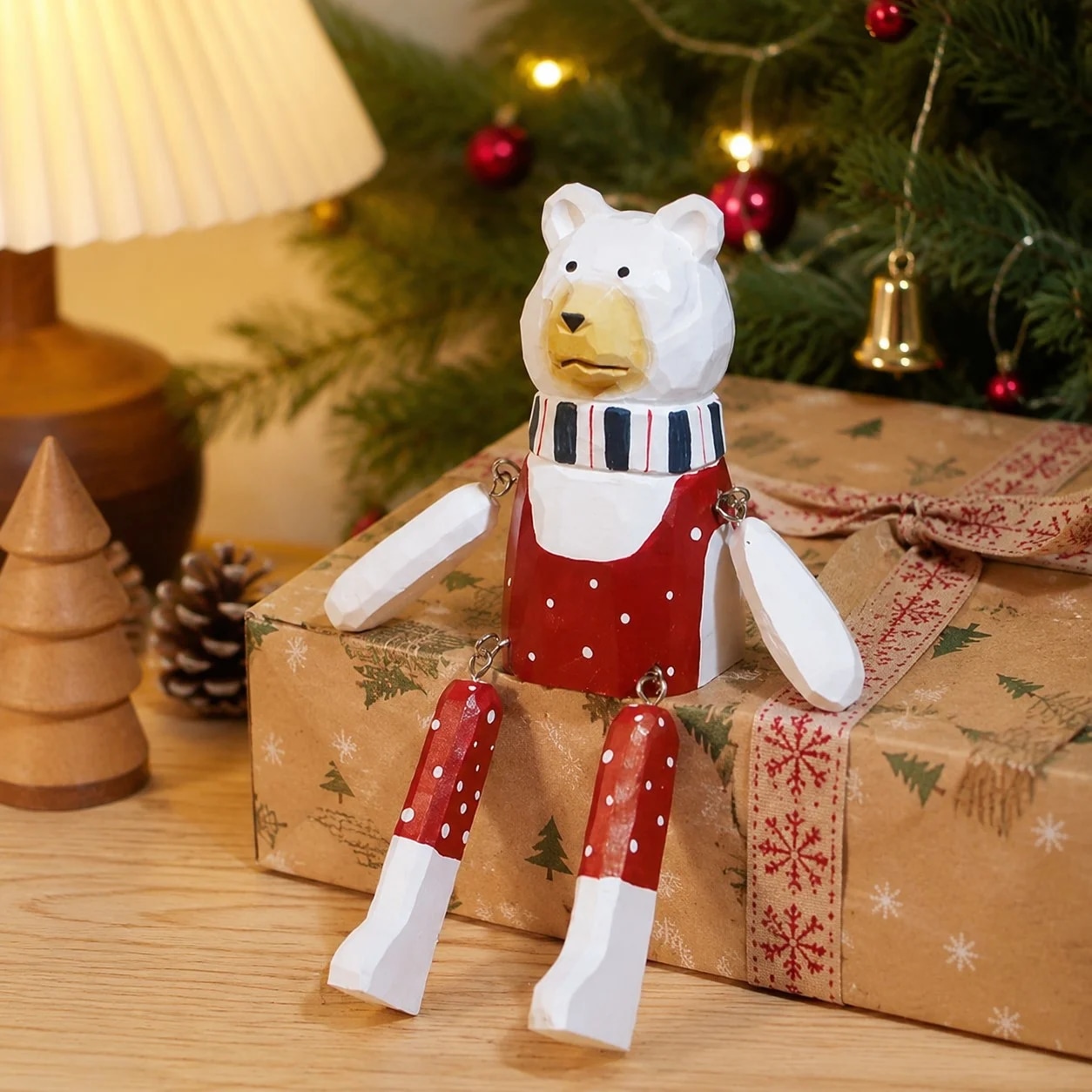 Hand-carved wooden christmas polar bear ornament styled on a tabletop edge