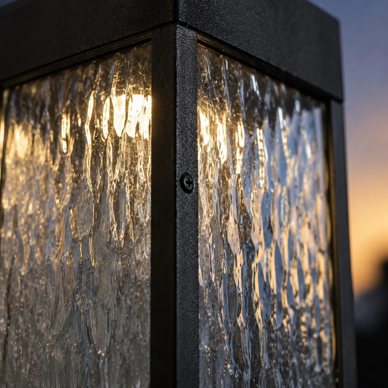 Close-up of rippled clear shade and matte black wall light frame