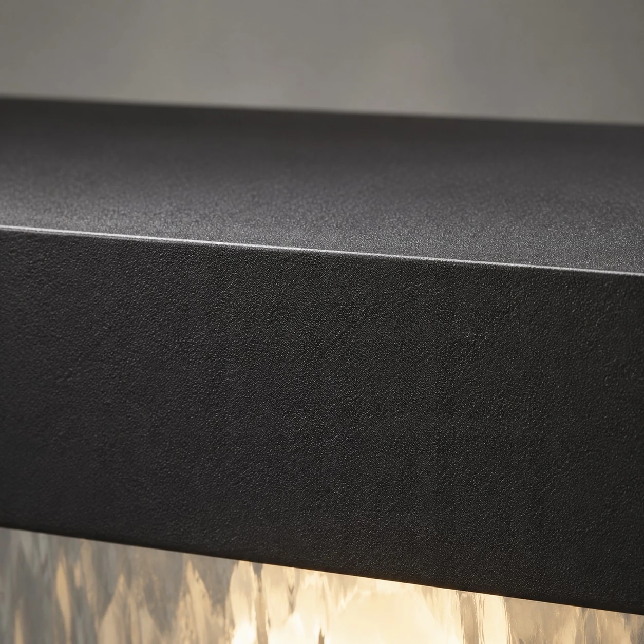 Close-up of matte black aluminum surface and upper frame edge
