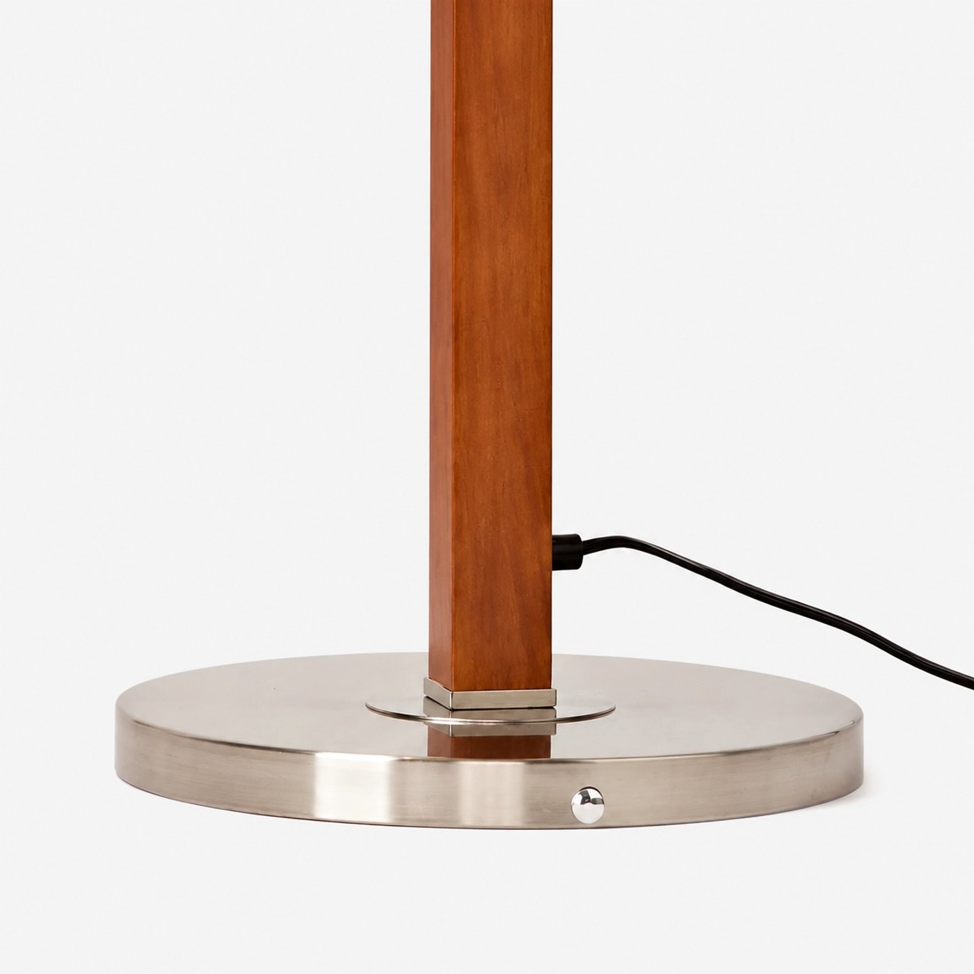 Round metal base and wood-tone pole detail