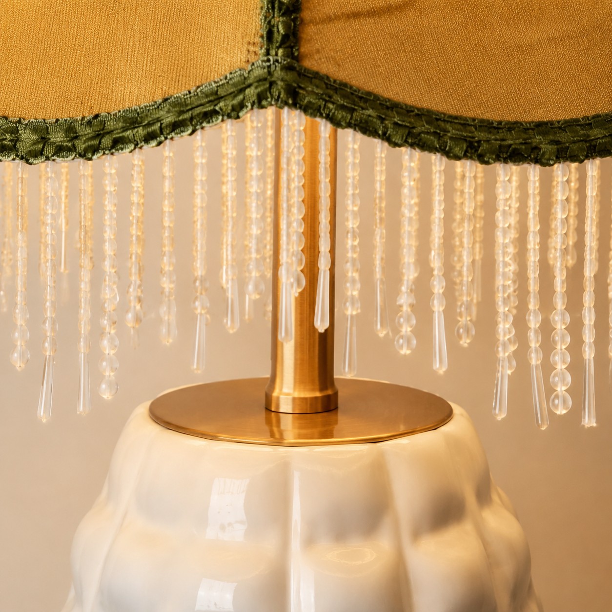 Close-up of beaded fringe and brass lamp fitting